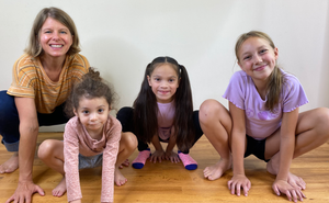 Chrisitne Stephenson with three happy kids, all in frog squats. 